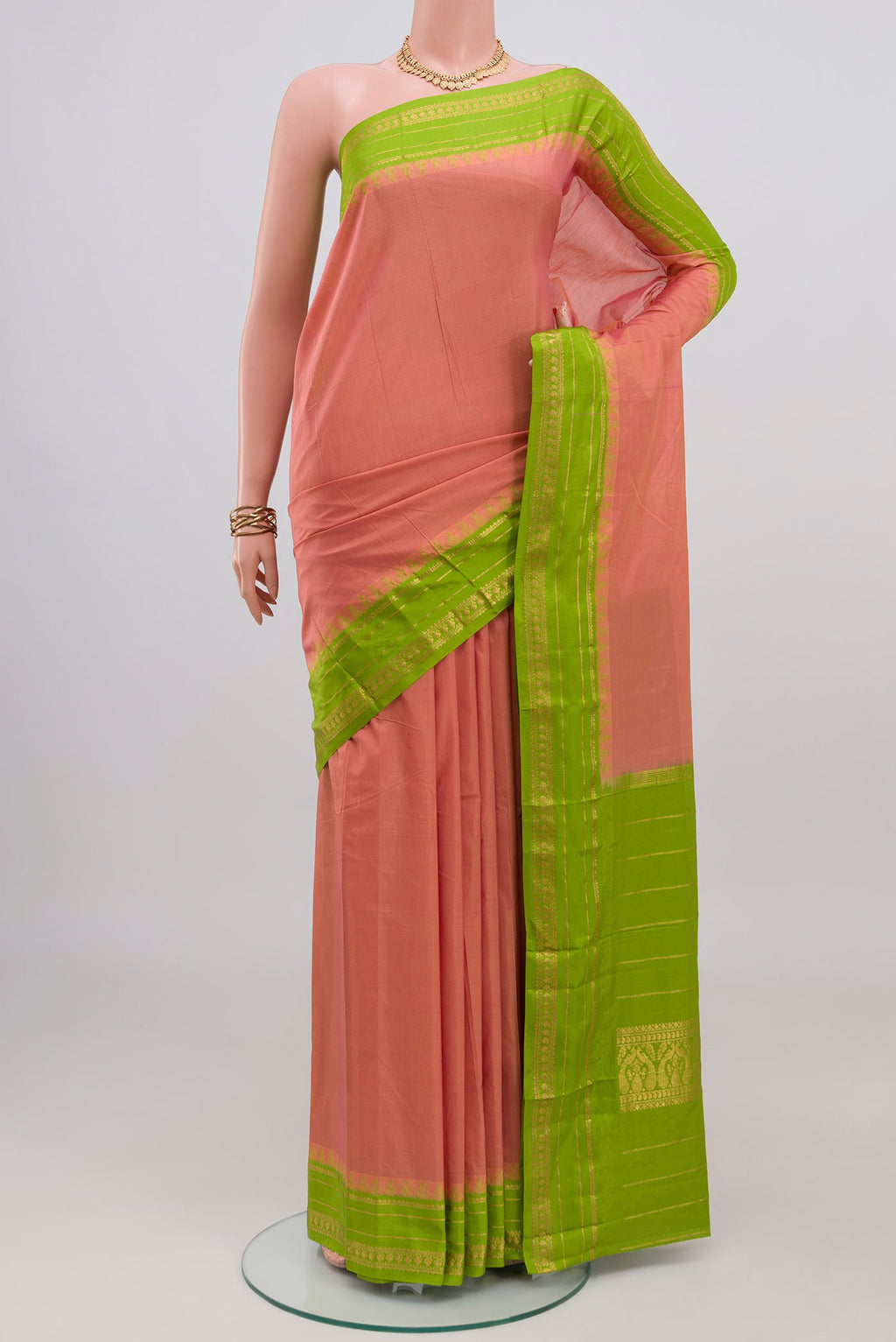 Peach Bangalore Silk Saree with Plain Body and Thin Zari Line.  displayed on a mannequin