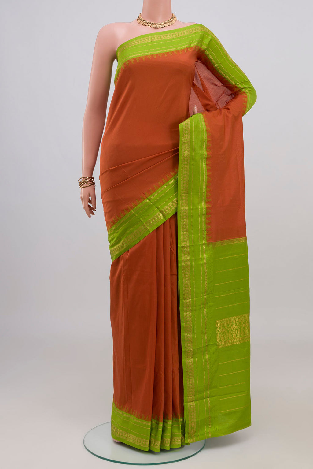 Rust Bangalore Silk Saree with Plain Body and Thin Zari Line.  displayed on a mannequin