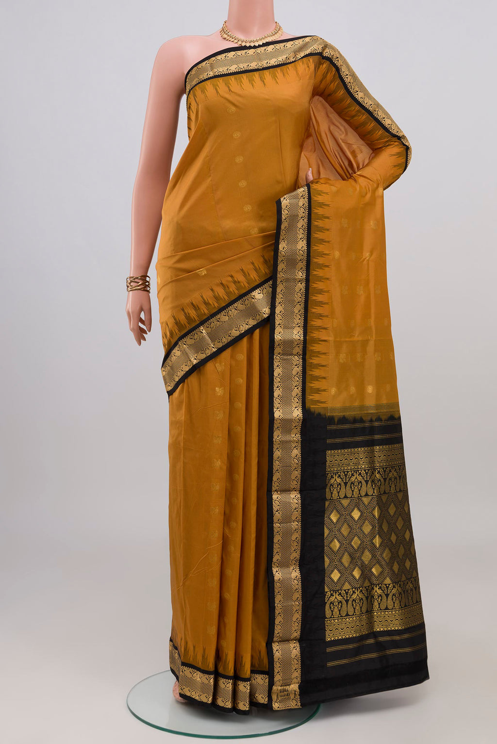 Mustard Bangalore Silk Saree with Zari Butta on the body and Zari Border.  displayed on a mannequin