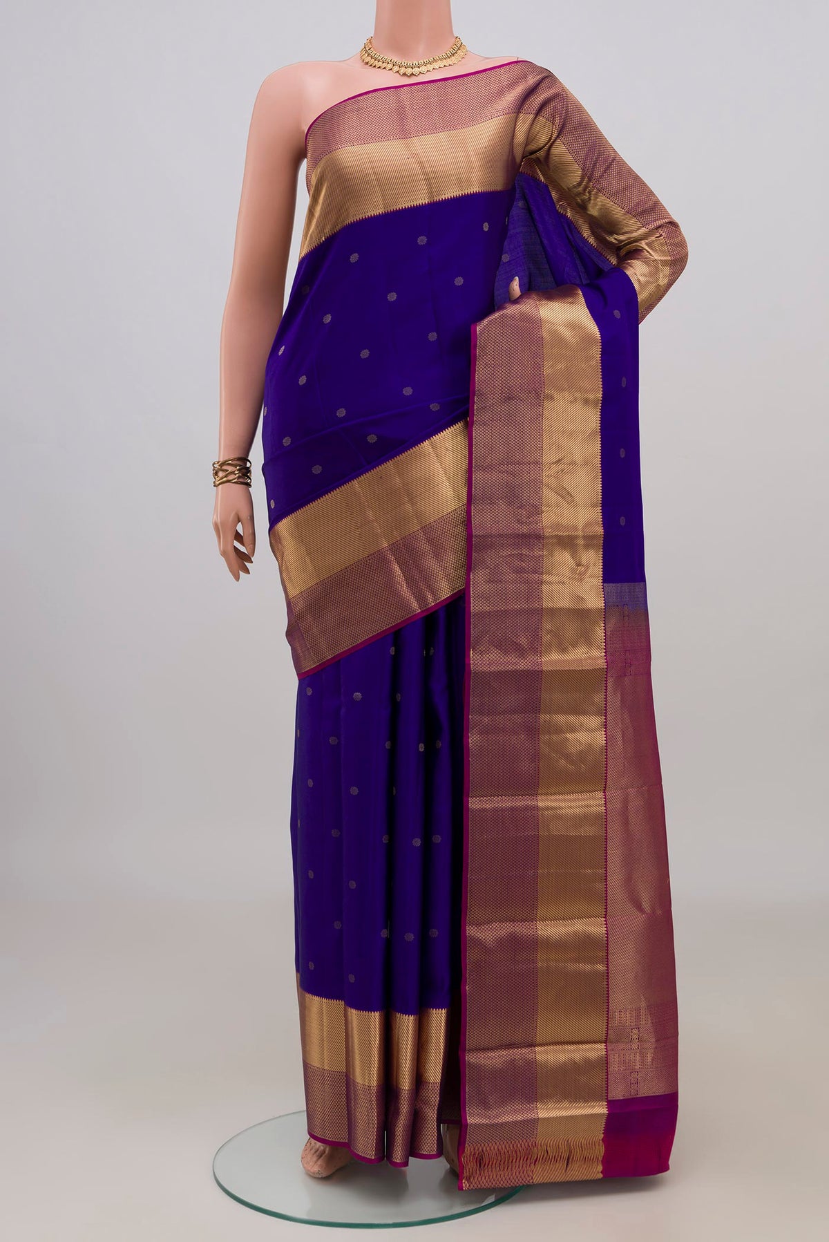 Pure Silk Blue Kanchipuram Saree with Zari Butta on the body and Zari Border.  displayed on a mannequin