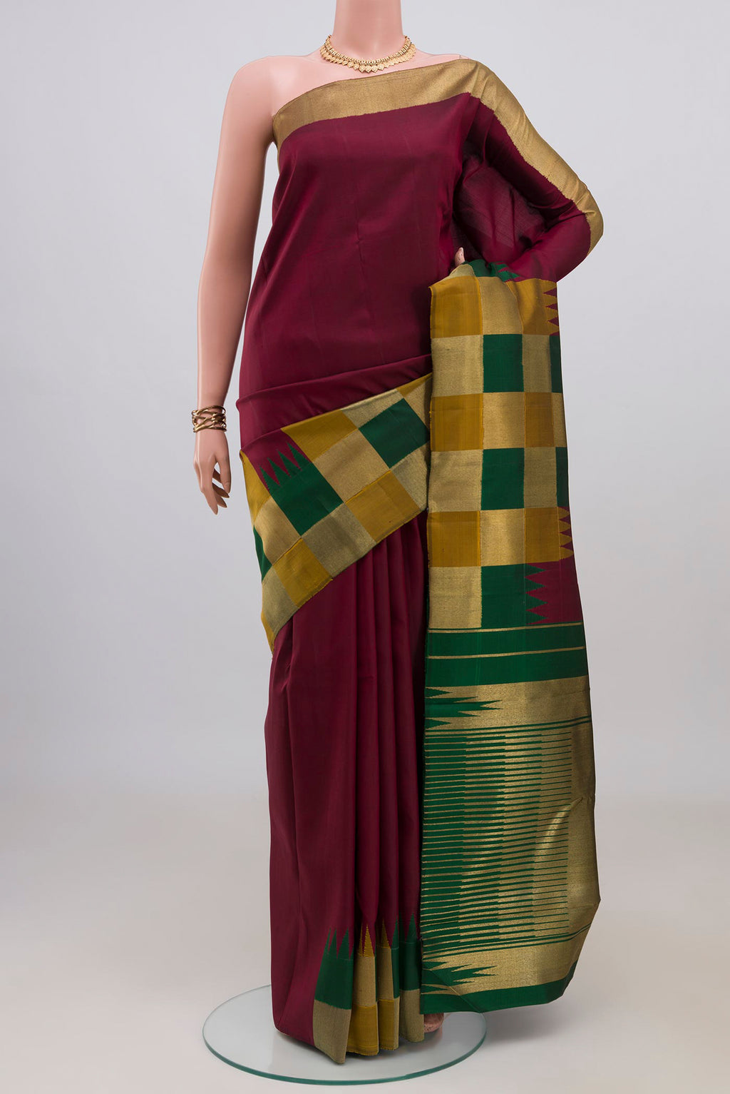 Pure Silk Maroon Kanchipuram Saree with Plain Body and Temple Border.  displayed on a mannequin