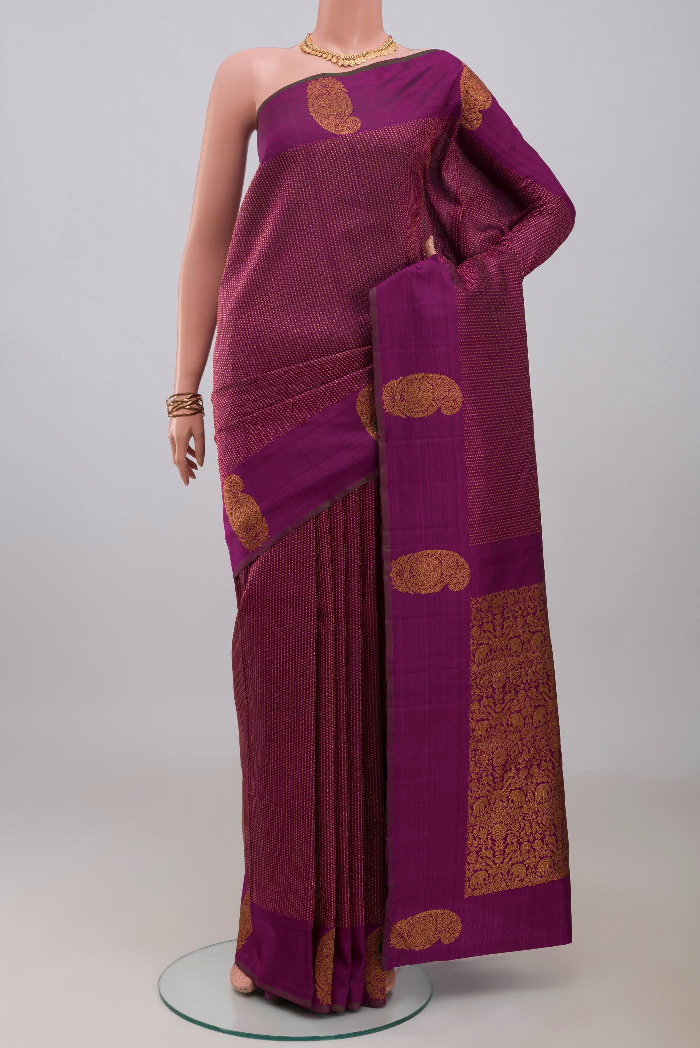 Purple Kanjivaram Silk Saree with Stripes on the body and Zari Border.  displayed on a mannequin