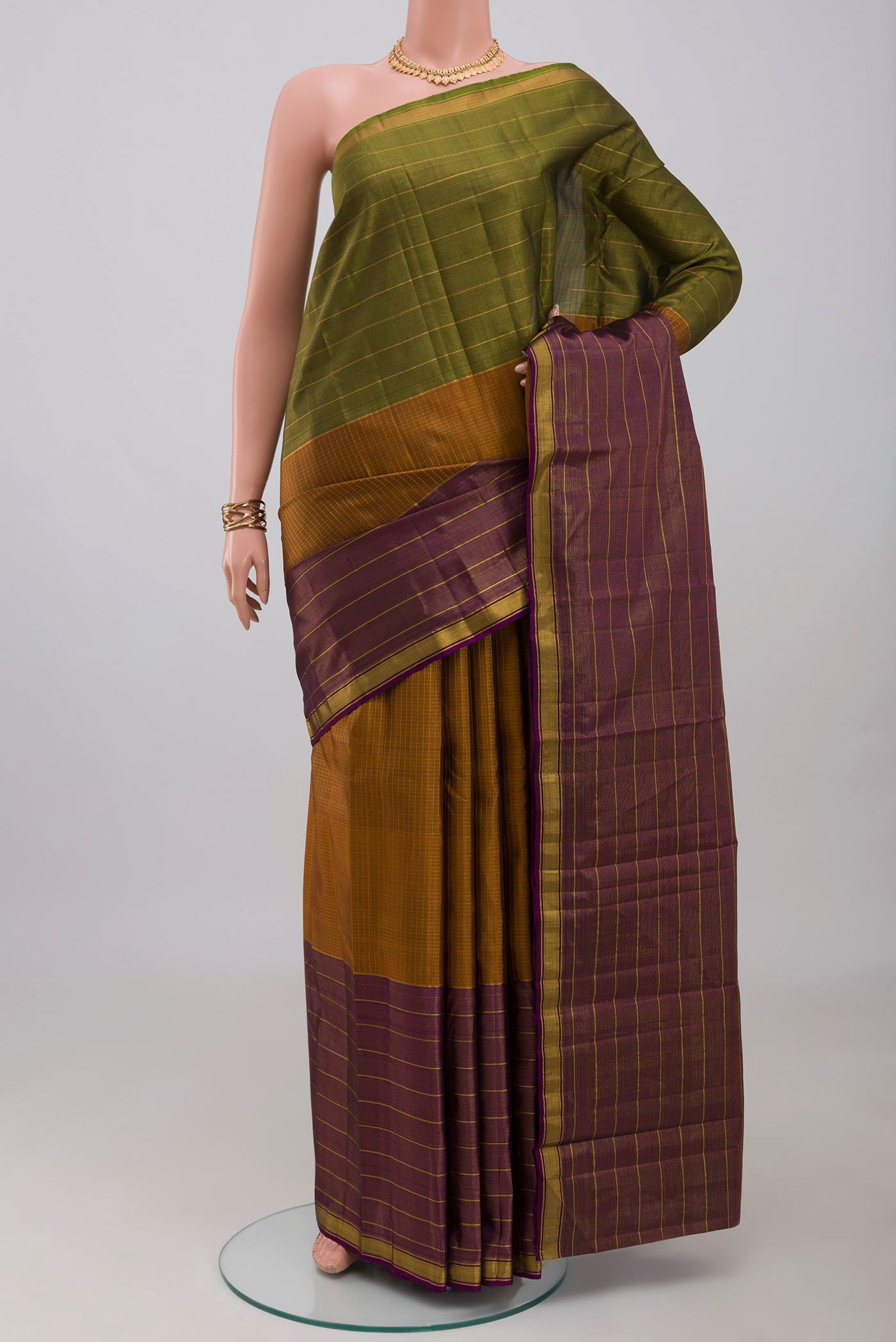 Pure Silk Pure Zari Mustard Kanjivaram Saree with Checked design on the body and Ganga Jamuna Border.  displayed on a mannequin