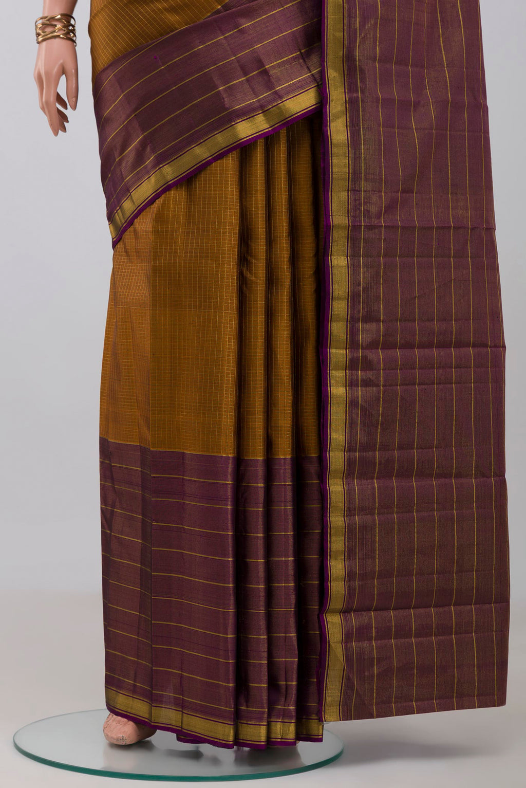 Pleats and pallu of Pure Silk Pure Zari Mustard Kanjivaram Saree with Checked design on the body and Ganga Jamuna Border. 