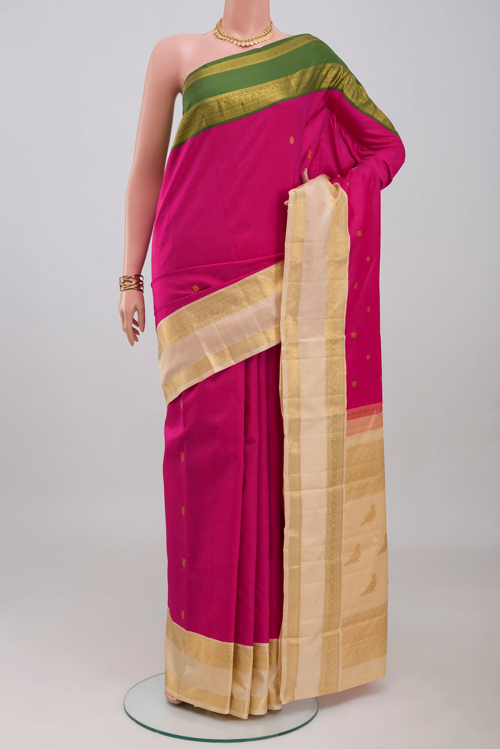 Rani Pink Kanjivaram Silk Saree with Zari Butta on the body and Ganga Jamuna Border.  displayed on a mannequin