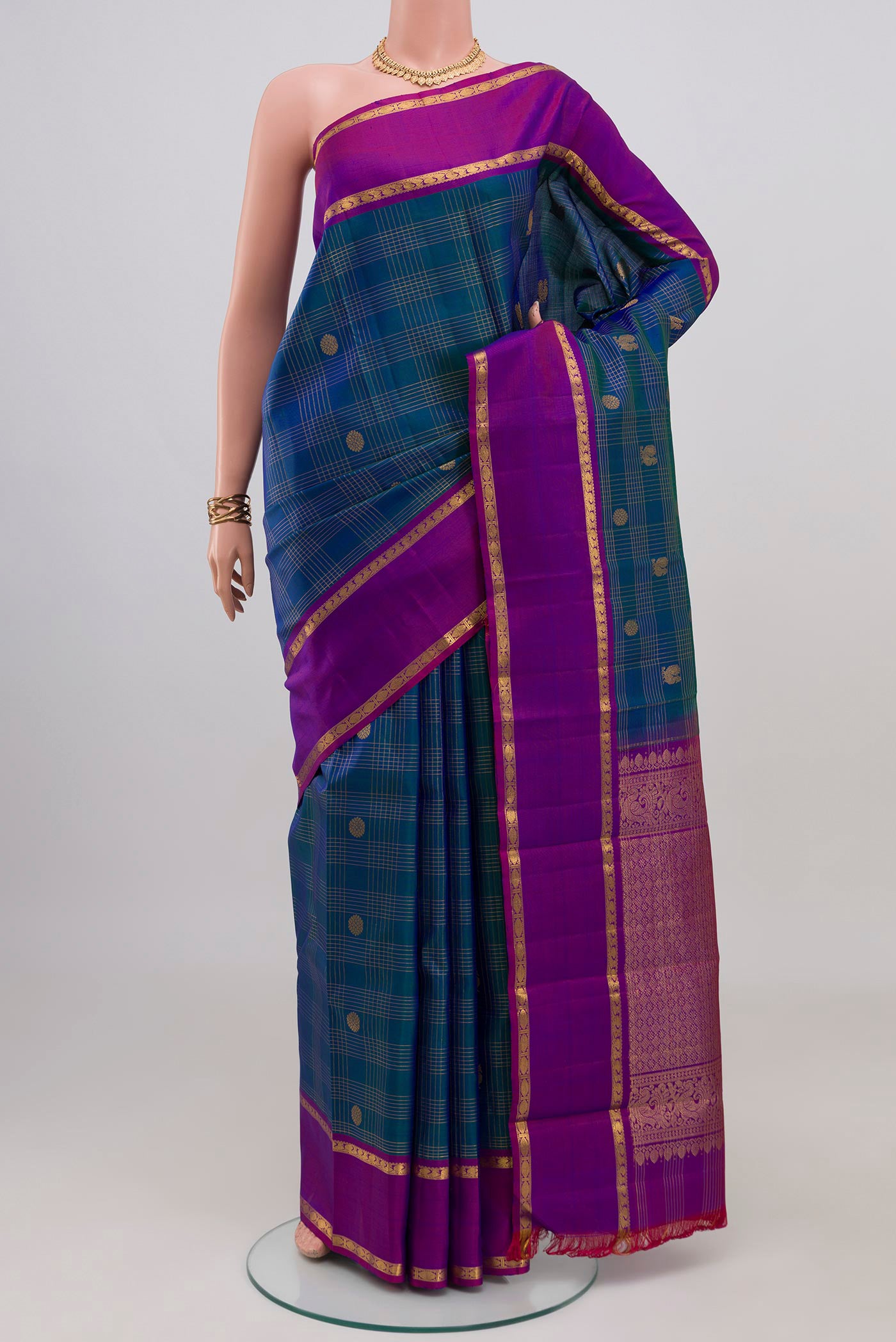Peacock Blue Kanjivaram Silk Saree with Checked design on the body and Plain Border.  displayed on a mannequin