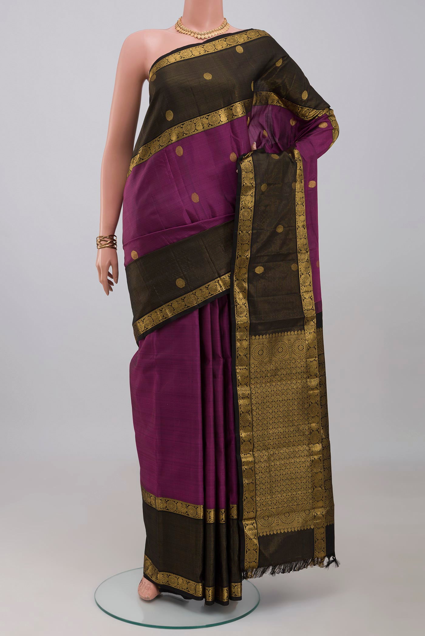 Purple Kanjivaram Silk Saree with Zari Butta on the body and Zari Border.  displayed on a mannequin