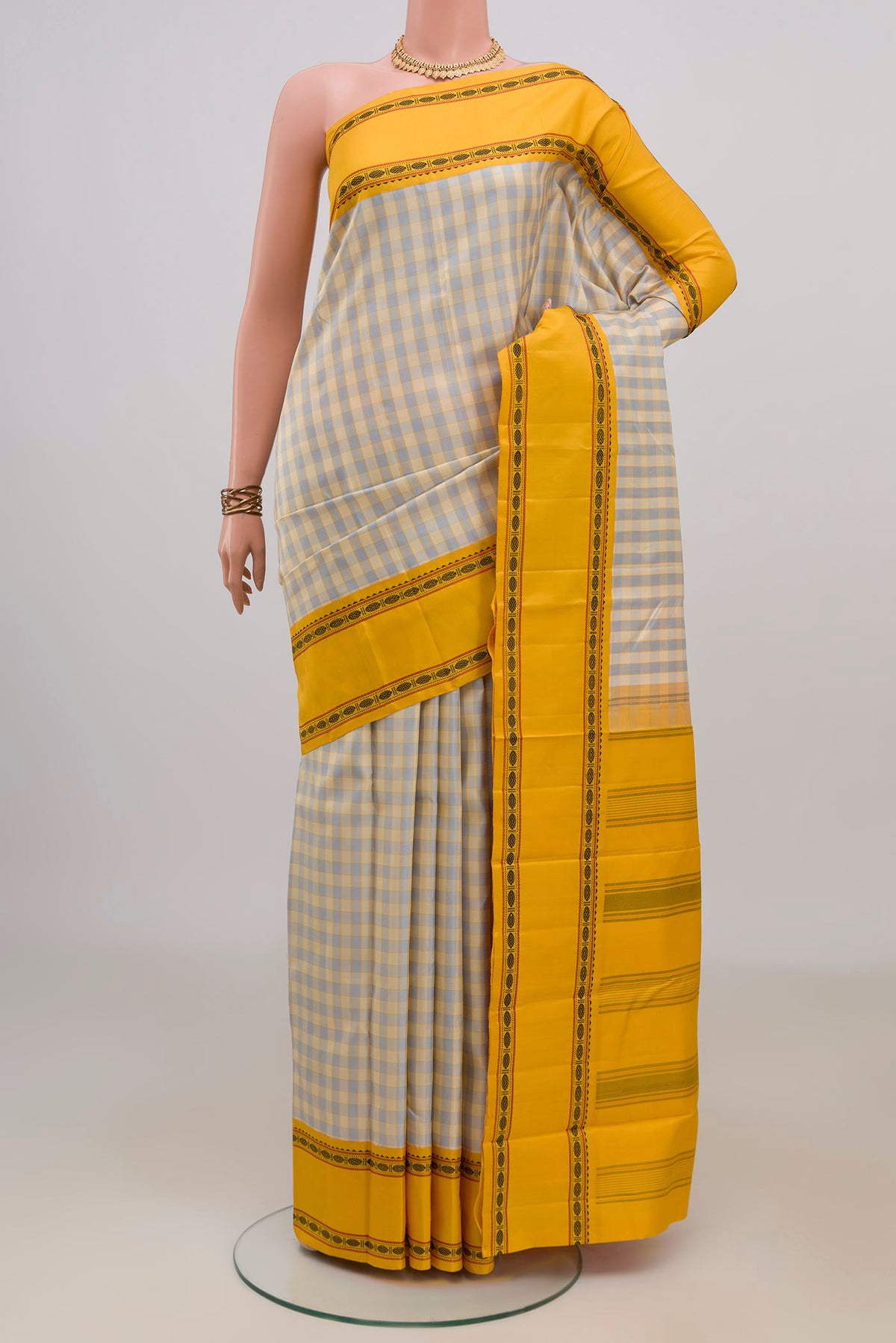 Pure Silk Beige Kanjivaram Saree with Checked design on the body and Thread Border.  displayed on a mannequin
