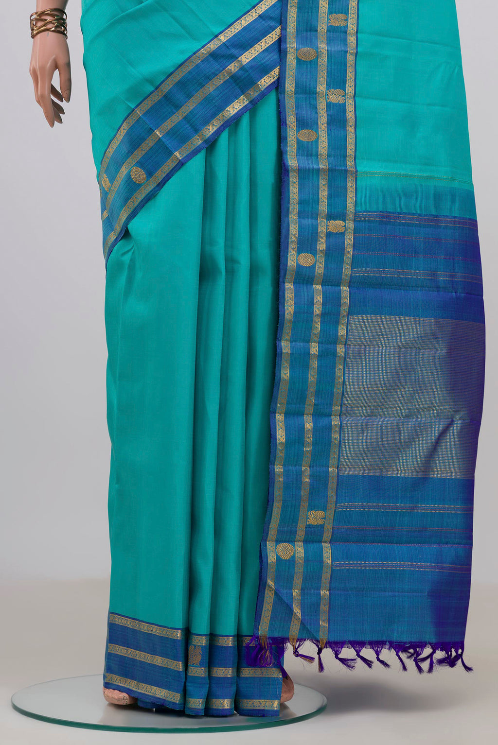 Pleats and pallu of Pure Silk Turquoise Kanchipuram Saree with Plain Body and Fancy Border. 