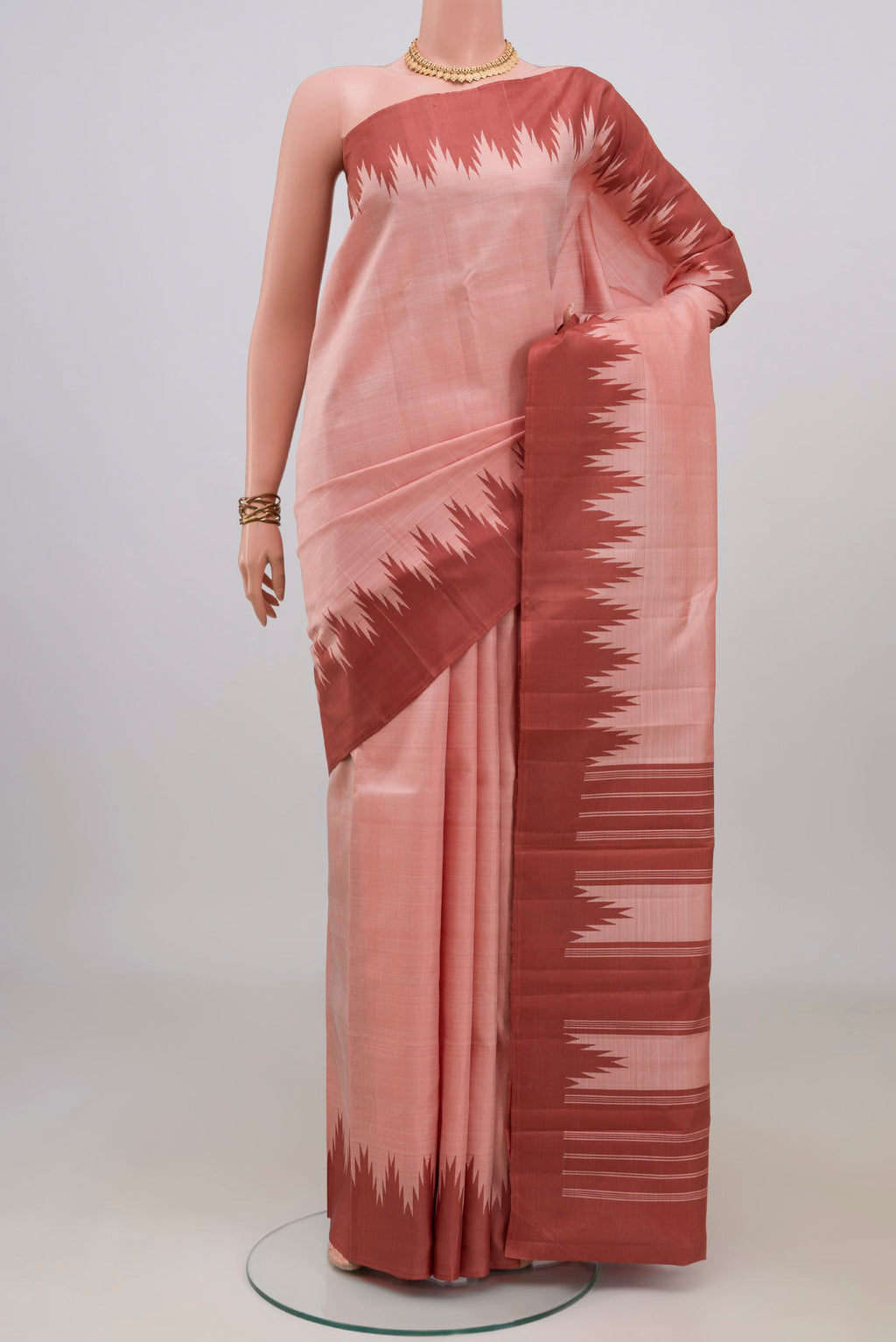 Pure Silk Peach Kanchipuram Saree with Plain Body and Temple Thread Border.  displayed on a mannequin
