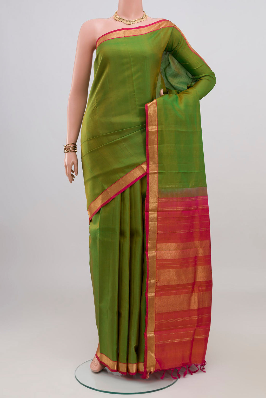 Green Kanchipuram Silk Saree with Plain Body and Zari Border.  displayed on a mannequin