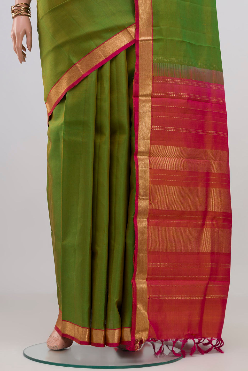 Pleats and pallu of Green Kanchipuram Silk Saree with Plain Body and Zari Border. 