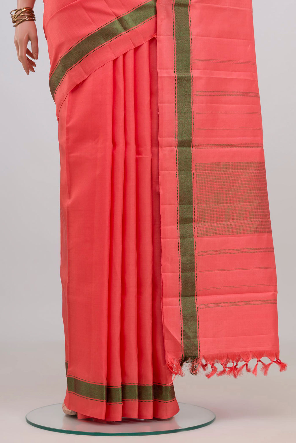 Pleats and pallu of Peach Kanchipuram Silk Saree with Plain Body and Thread Border. 