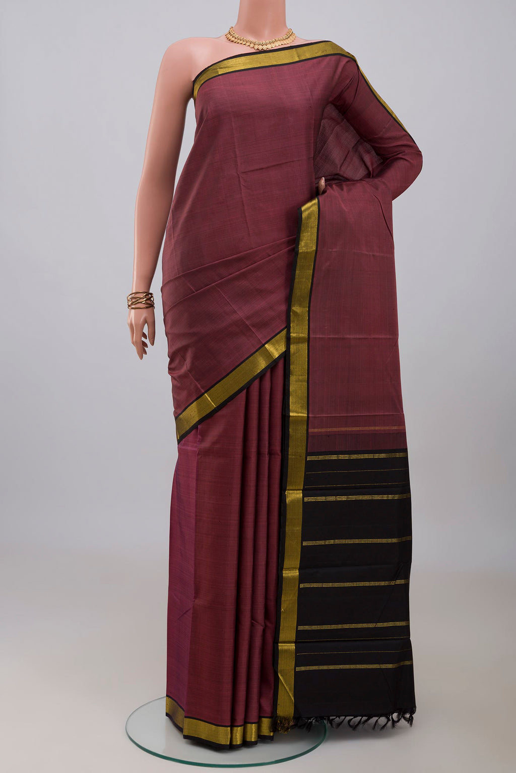 Mauve Kanchipuram Silk Saree with Plain Body and Zari Border.  displayed on a mannequin