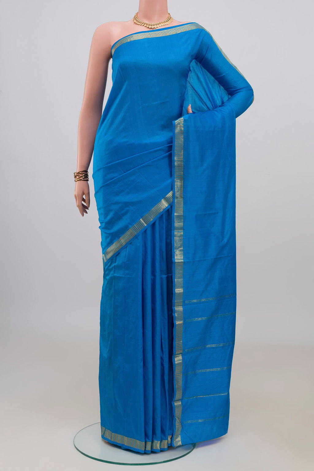 Pure Silk Blue Kanchipuram Saree with Plain Body and Zari Border.  displayed on a mannequin