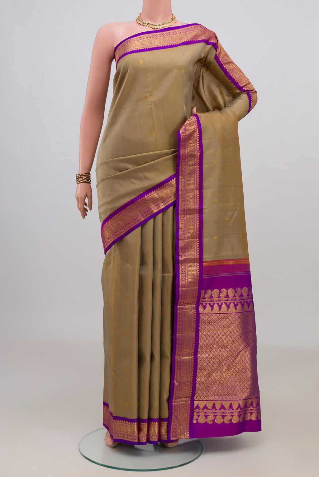 Pure Silk Beige Kanchipuram Saree with Zari Butta on the body and Zari Border.  displayed on a mannequin
