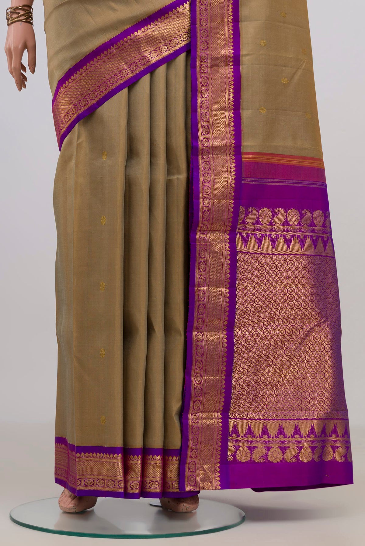 Pleats and pallu of Pure Silk Beige Kanchipuram Saree with Zari Butta on the body and Zari Border. 