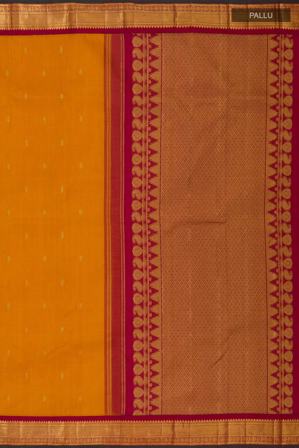 Close up image of the pallu of Yellow Kanchipuram Silk Saree with Zari Butta on the body and Zari Border. 