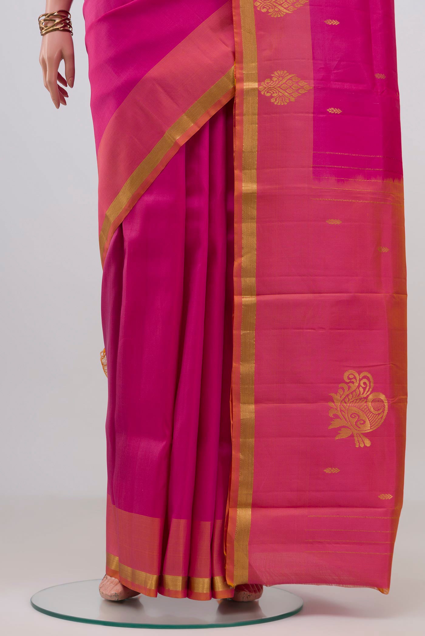 Pleats and pallu of Pink Kanchipuram Silk Saree with Zari Butta on the body and Zari Border. 