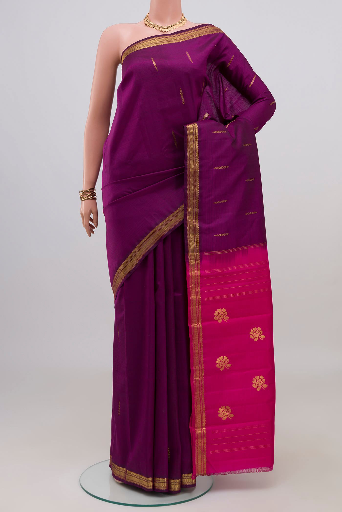 Purple Kanchipuram Silk Saree with Zari Butta on the body and Zari Border.  displayed on a mannequin
