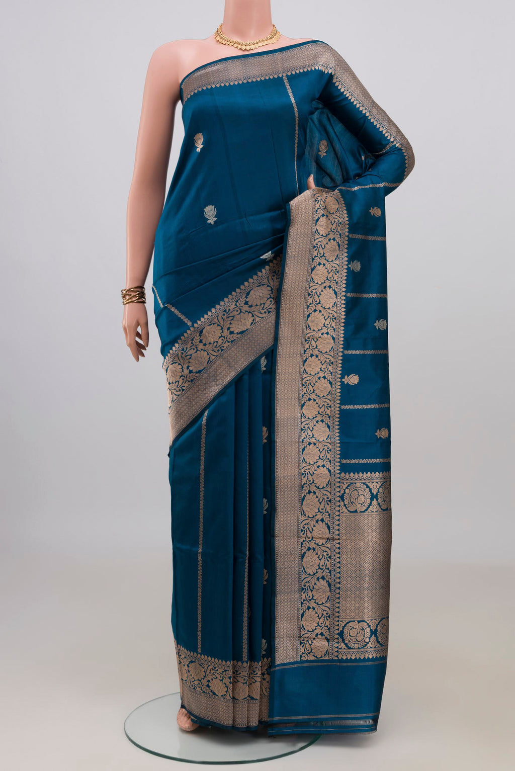 Pure Silk Blue Banarasi Katan Saree with Zari Butta on the body and Zari Border.  displayed on a mannequin