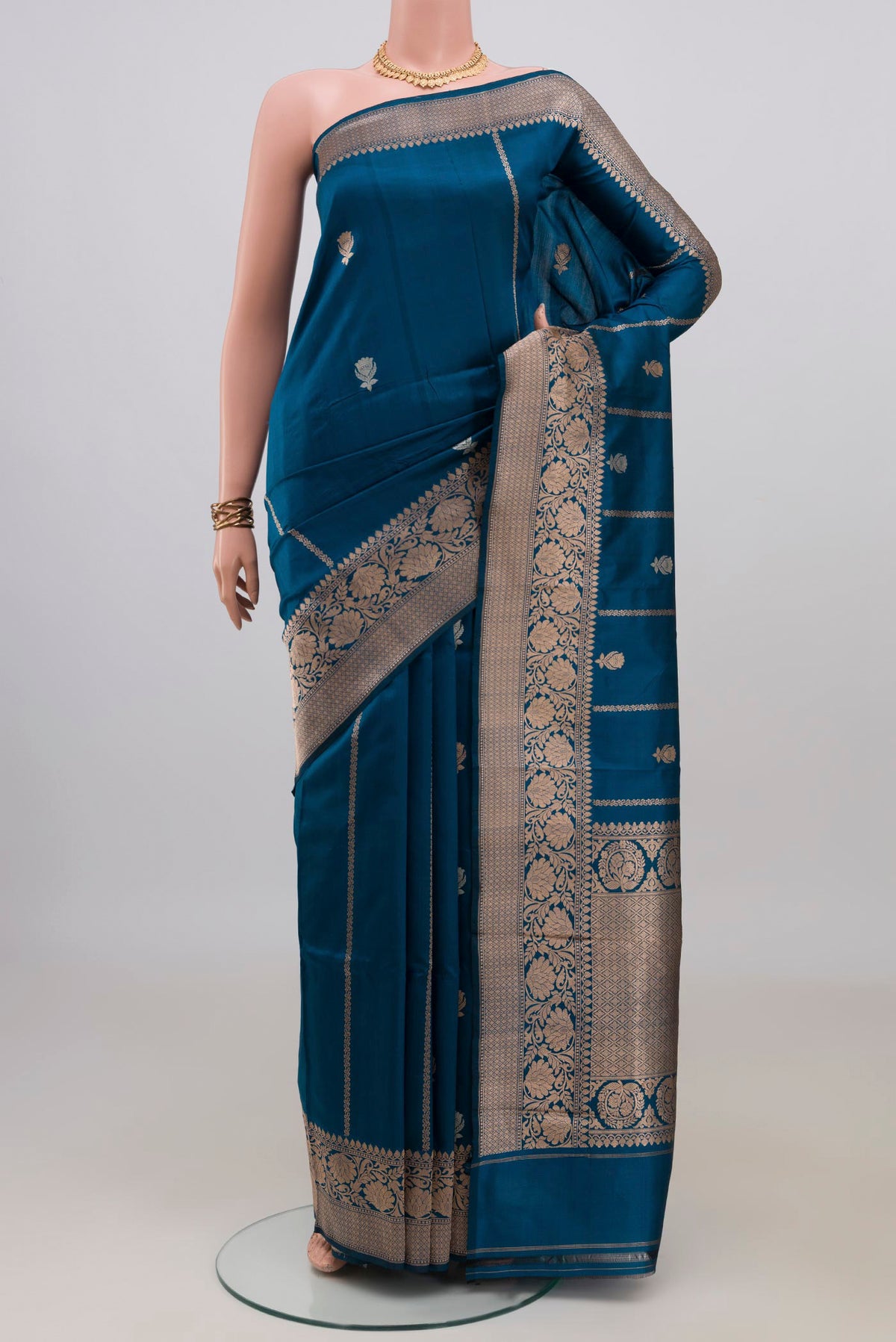 Pure Silk Blue Banarasi Katan Saree with Zari Butta on the body and Zari Border.  displayed on a mannequin