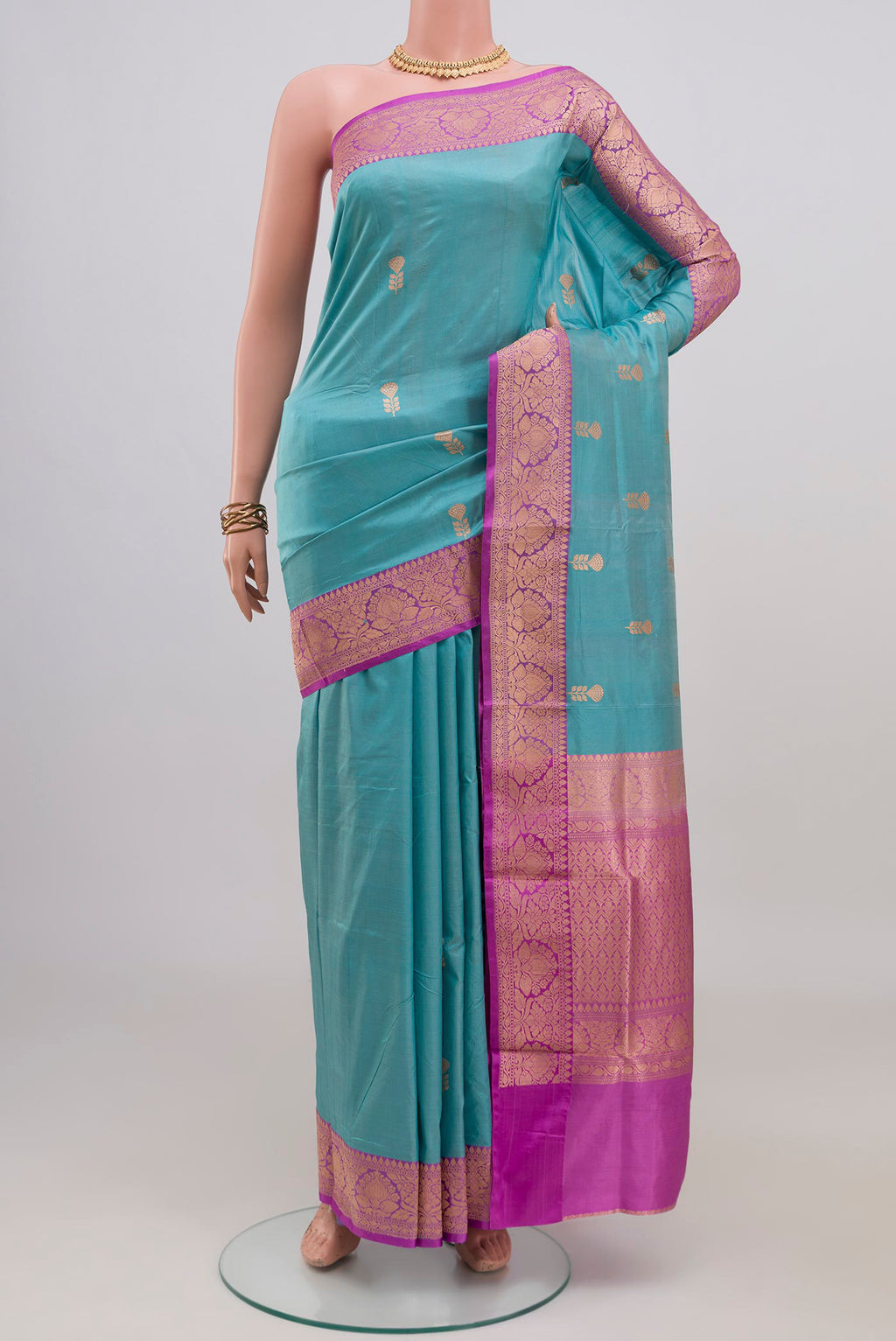 Light Blue Banarasi Katan Silk Saree with Zari Butta on the body and Fancy Border.  displayed on a mannequin