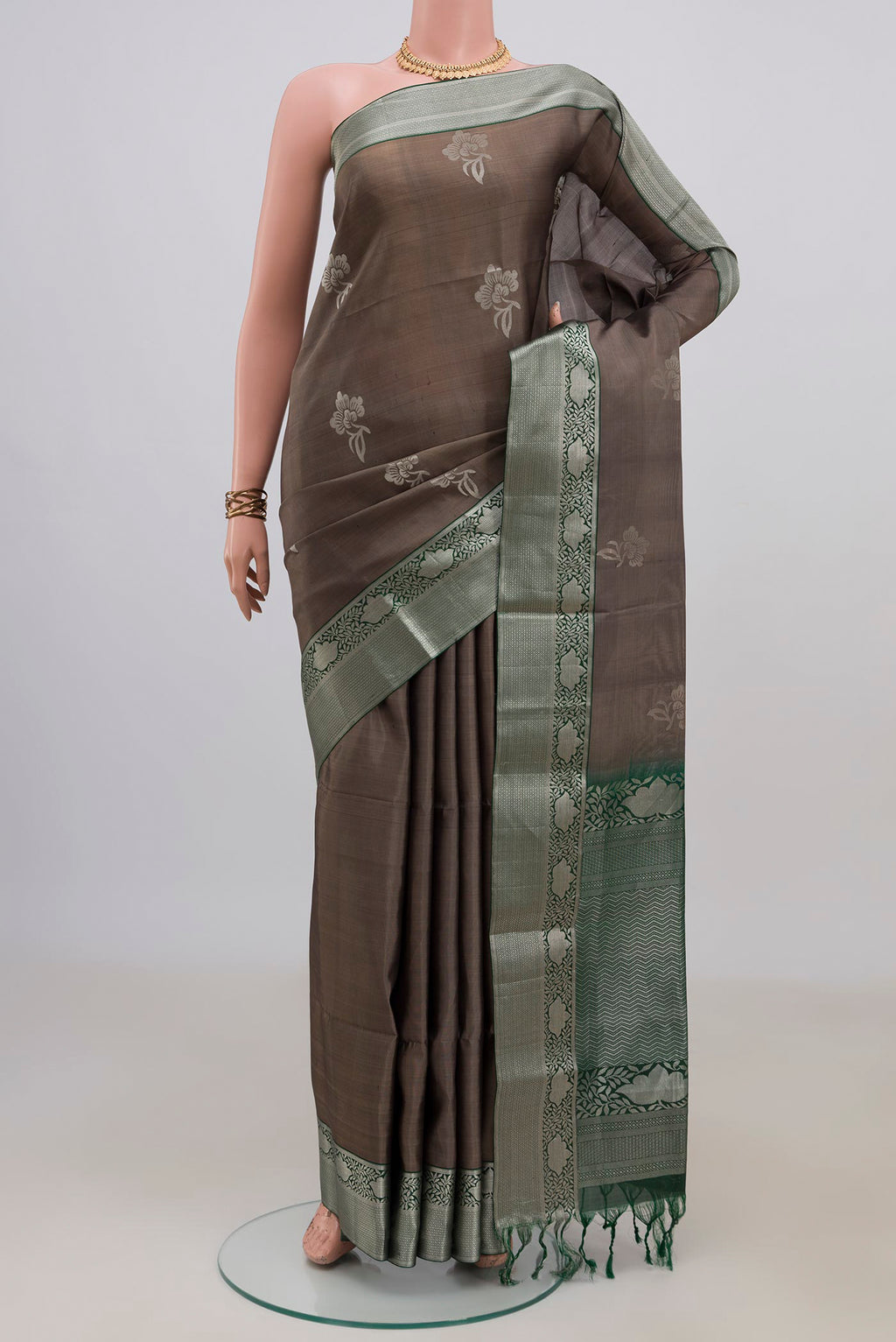 Pure Silk Grey Soft Saree with Zari Butta on the body and Zari Border.  displayed on a mannequin