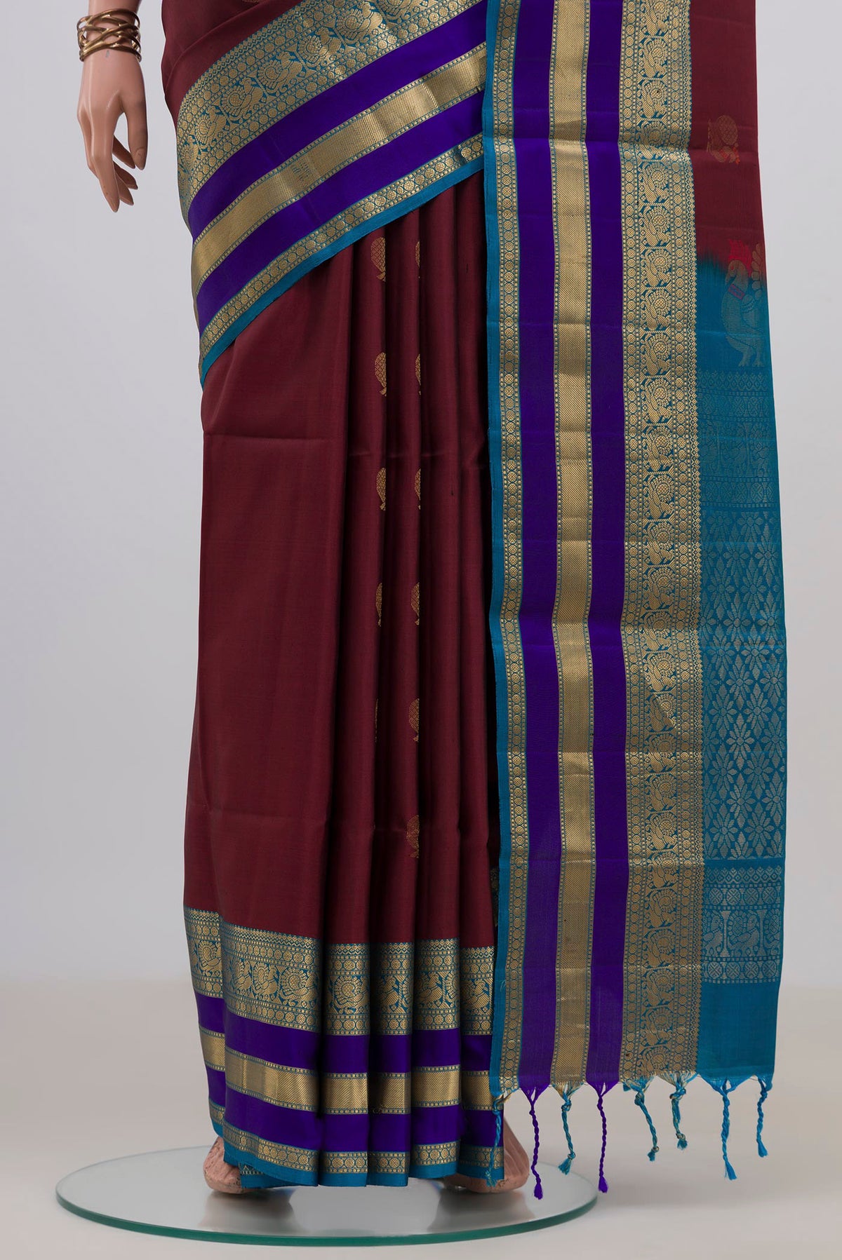 Pleats and pallu of Pure Silk Maroon Soft Saree with Zari Butta on the body and Zari Border. 