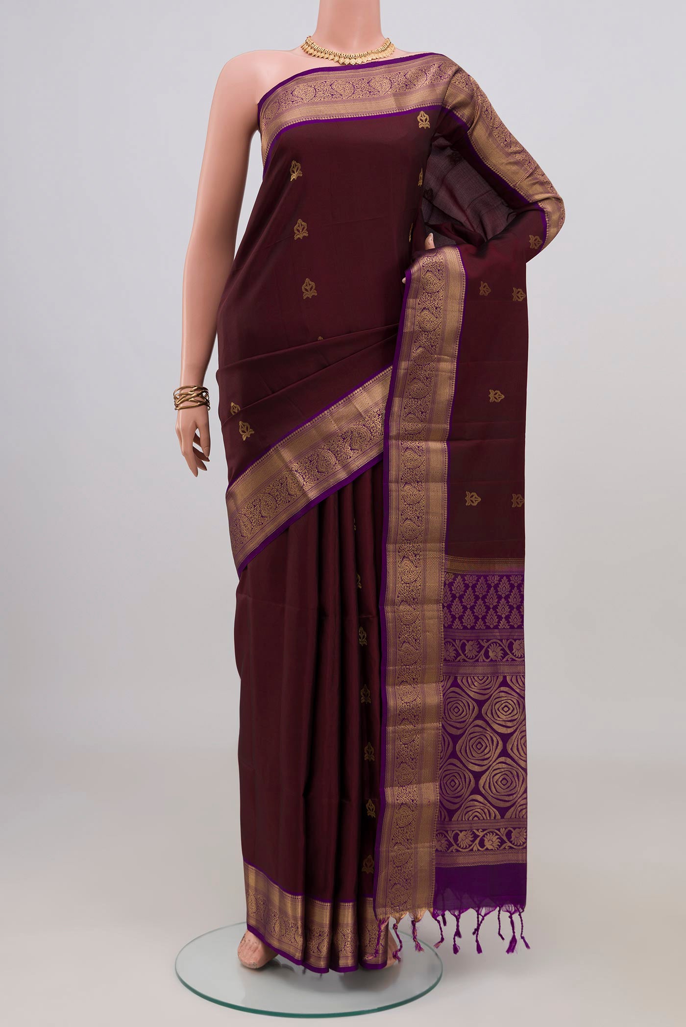 Coffee Brown Soft Silk Saree with Zari Butta on the body and Zari Border.  displayed on a mannequin