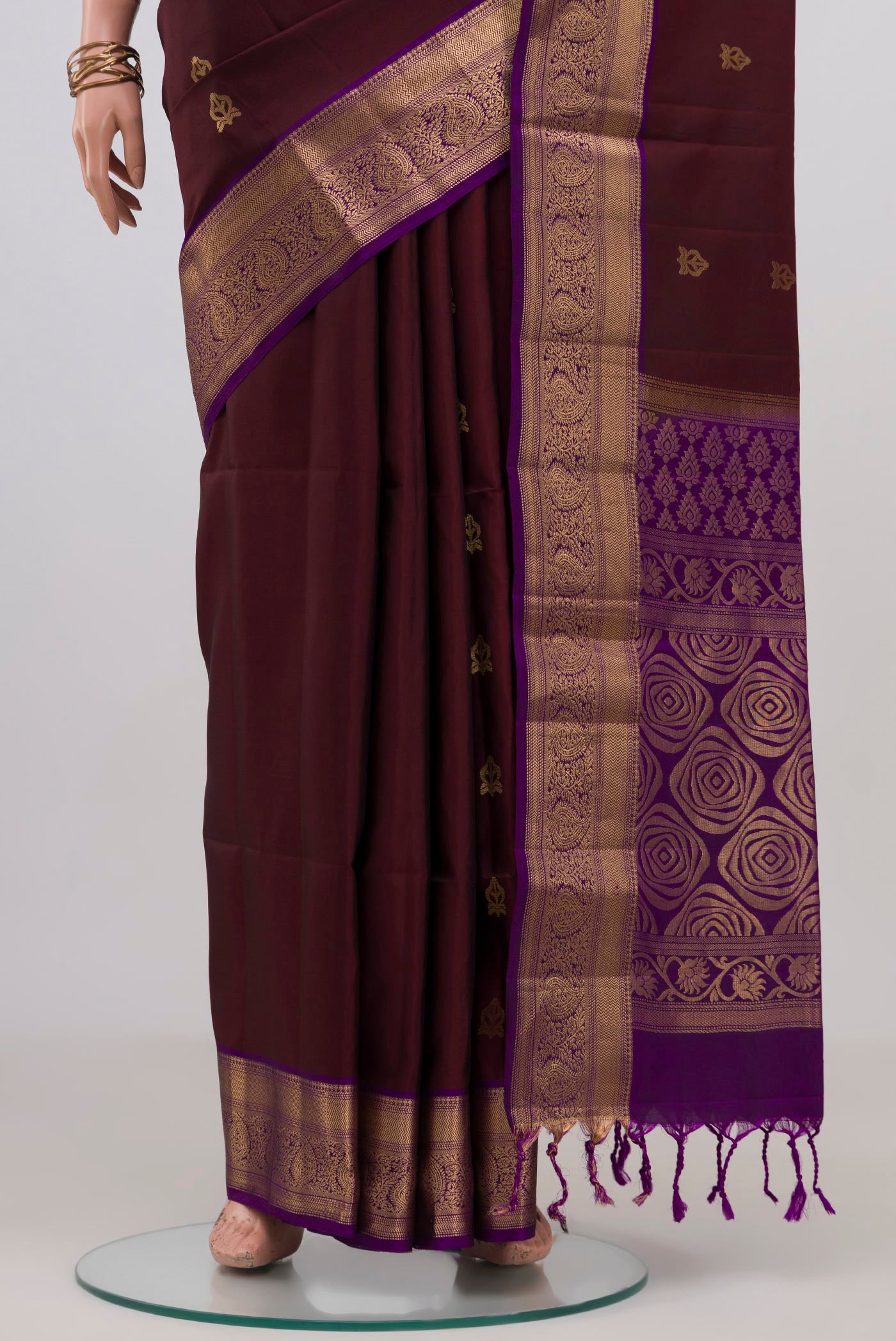 Pleats and pallu of Coffee Brown Soft Silk Saree with Zari Butta on the body and Zari Border. 