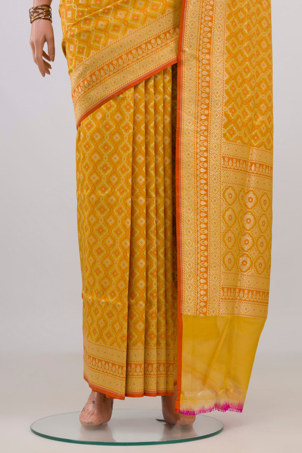 Pleats and pallu of Pure Silk Yellow Banarasi Saree with Jacquard With Zari Butta on the body and Zari Border. 