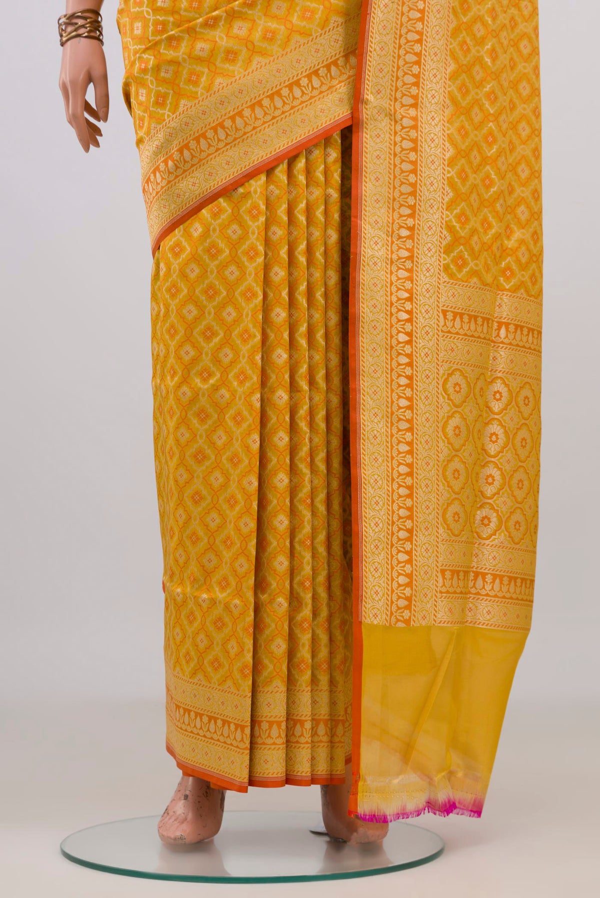 Pleats and pallu of Pure Silk Yellow Banarasi Saree with Jacquard With Zari Butta on the body and Zari Border. 