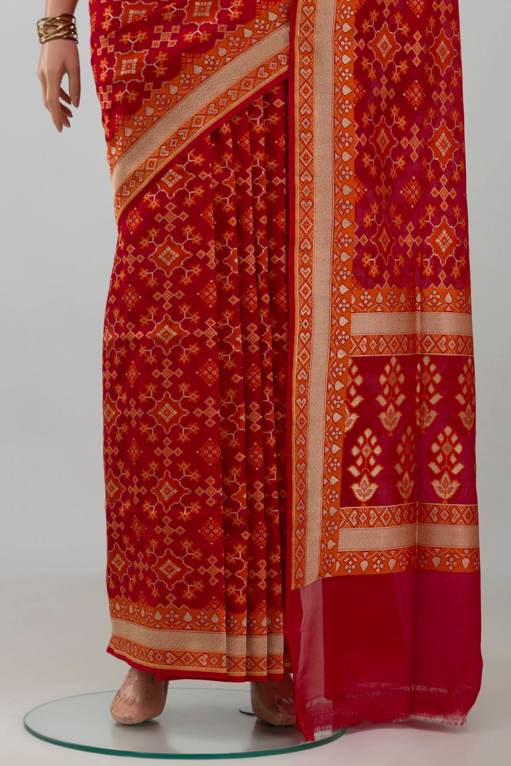 Pleats and pallu of Red Banarasi Silk Saree with Zari And Thread Butta on the body and Zari Border. 
