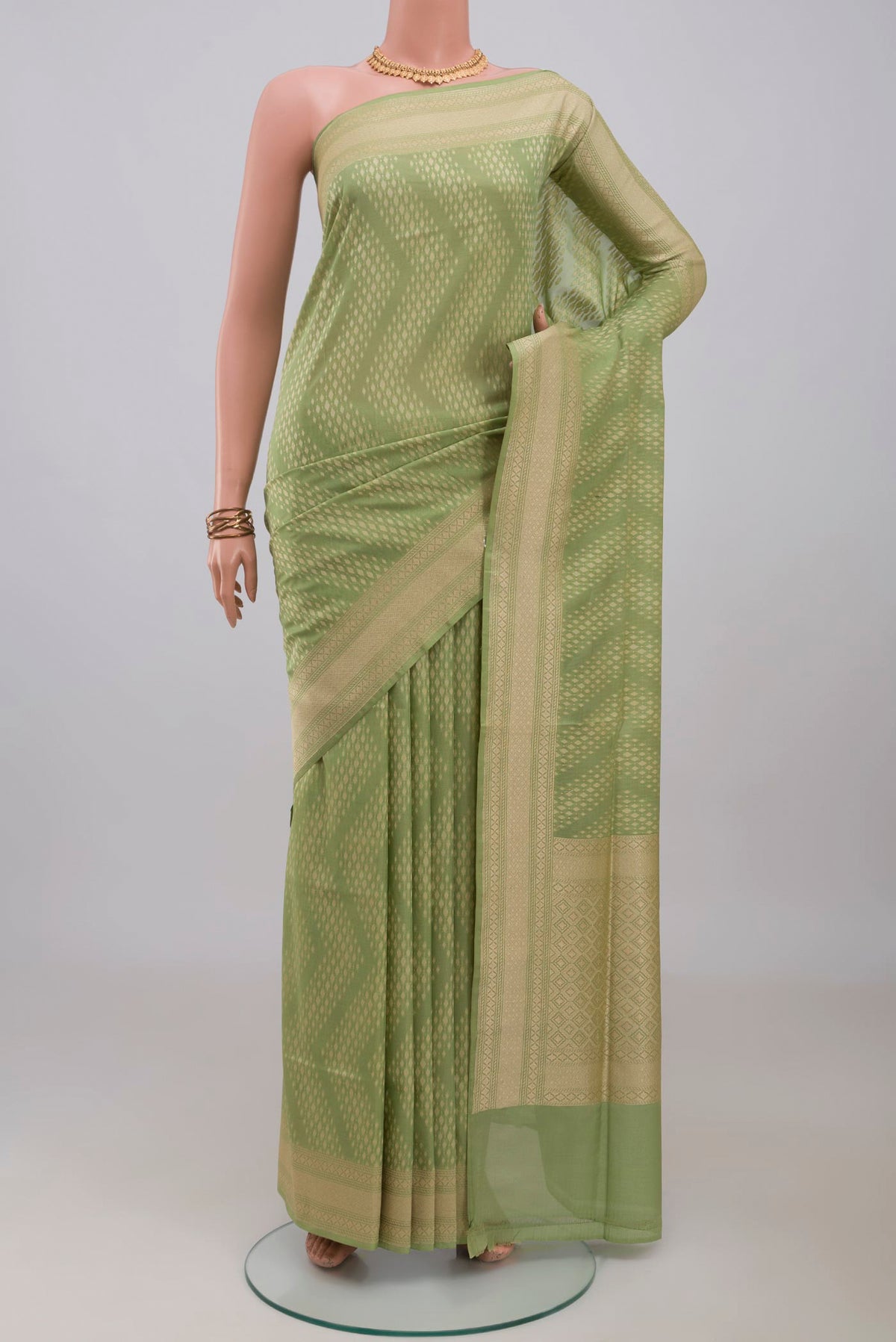 Light Green Banarasi Silk Saree with Zari Butta on the body and Zari Border.  displayed on a mannequin