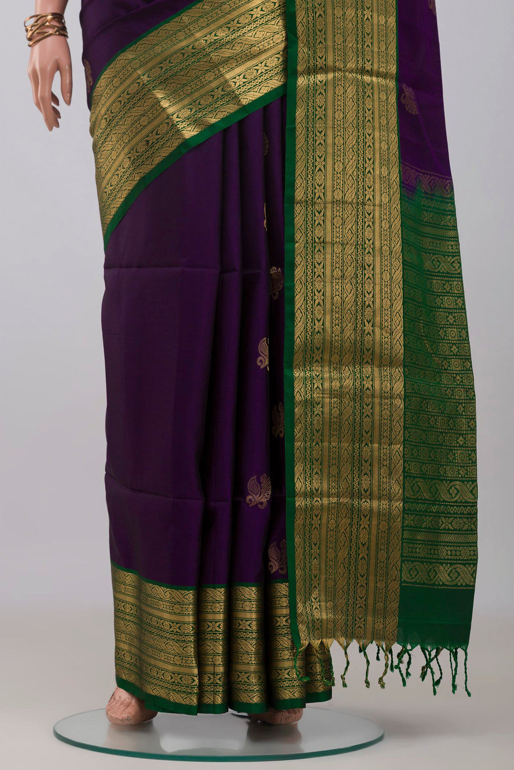 Pleats and pallu of Violet Soft Silk Saree with Zari Butta on the body and Zari Border. 