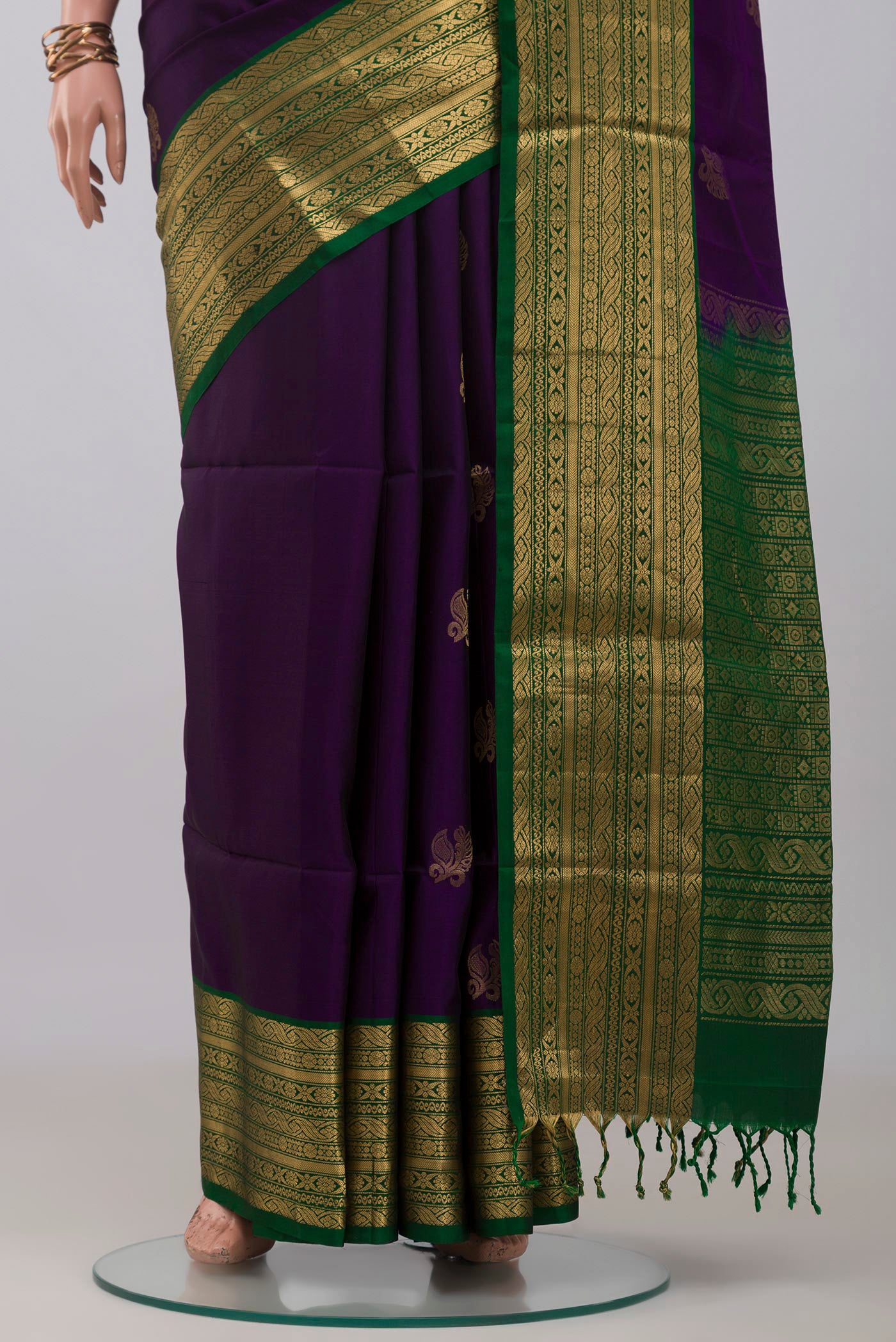 Pleats and pallu of Violet Soft Silk Saree with Zari Butta on the body and Zari Border. 