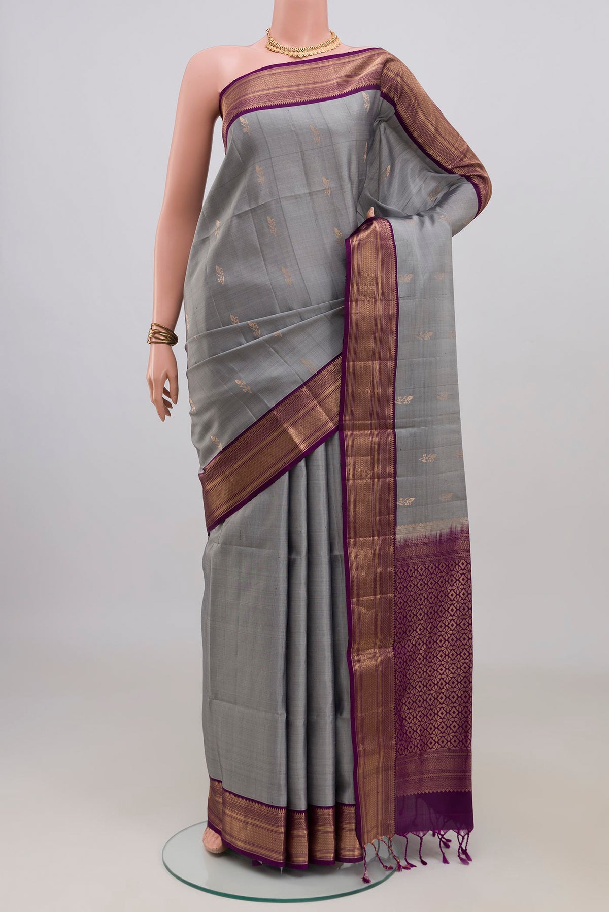 Pure Silk Grey Soft Saree with Zari Butta on the body and Zari Border.  displayed on a mannequin
