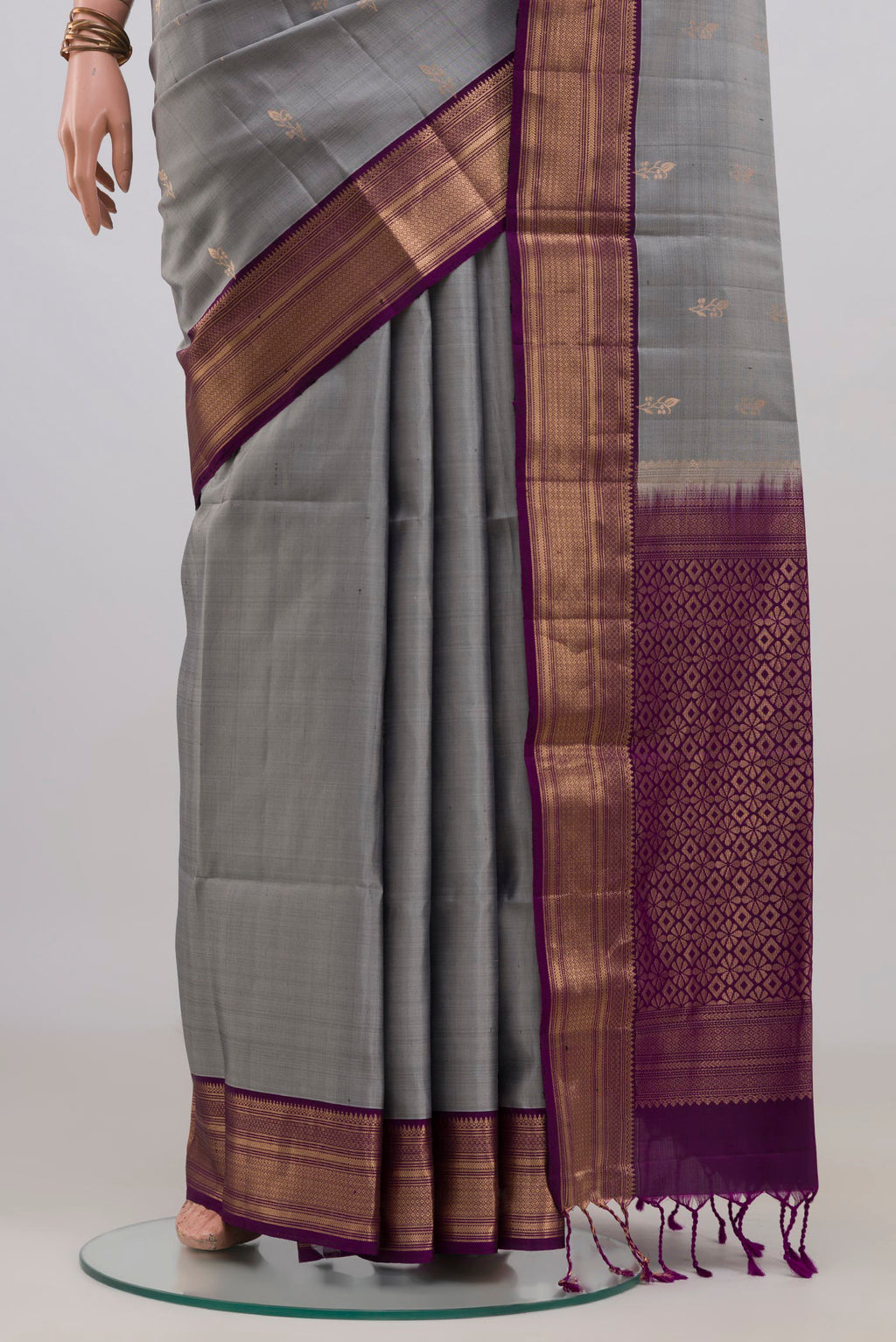 Pleats and pallu of Pure Silk Grey Soft Saree with Zari Butta on the body and Zari Border. 
