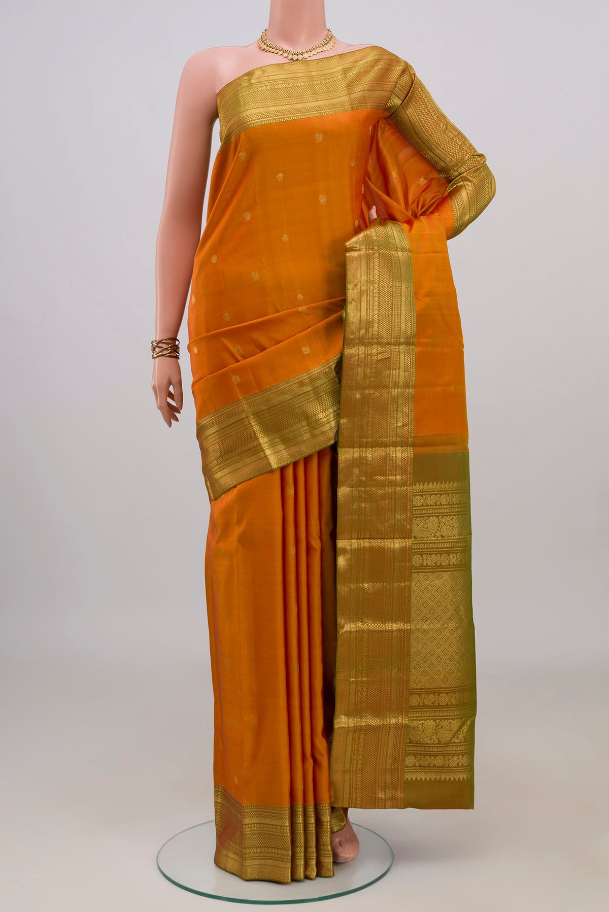 Pure Silk Yellow Kanchipuram Saree with Zari Butta on the body and Zari Border.  displayed on a mannequin