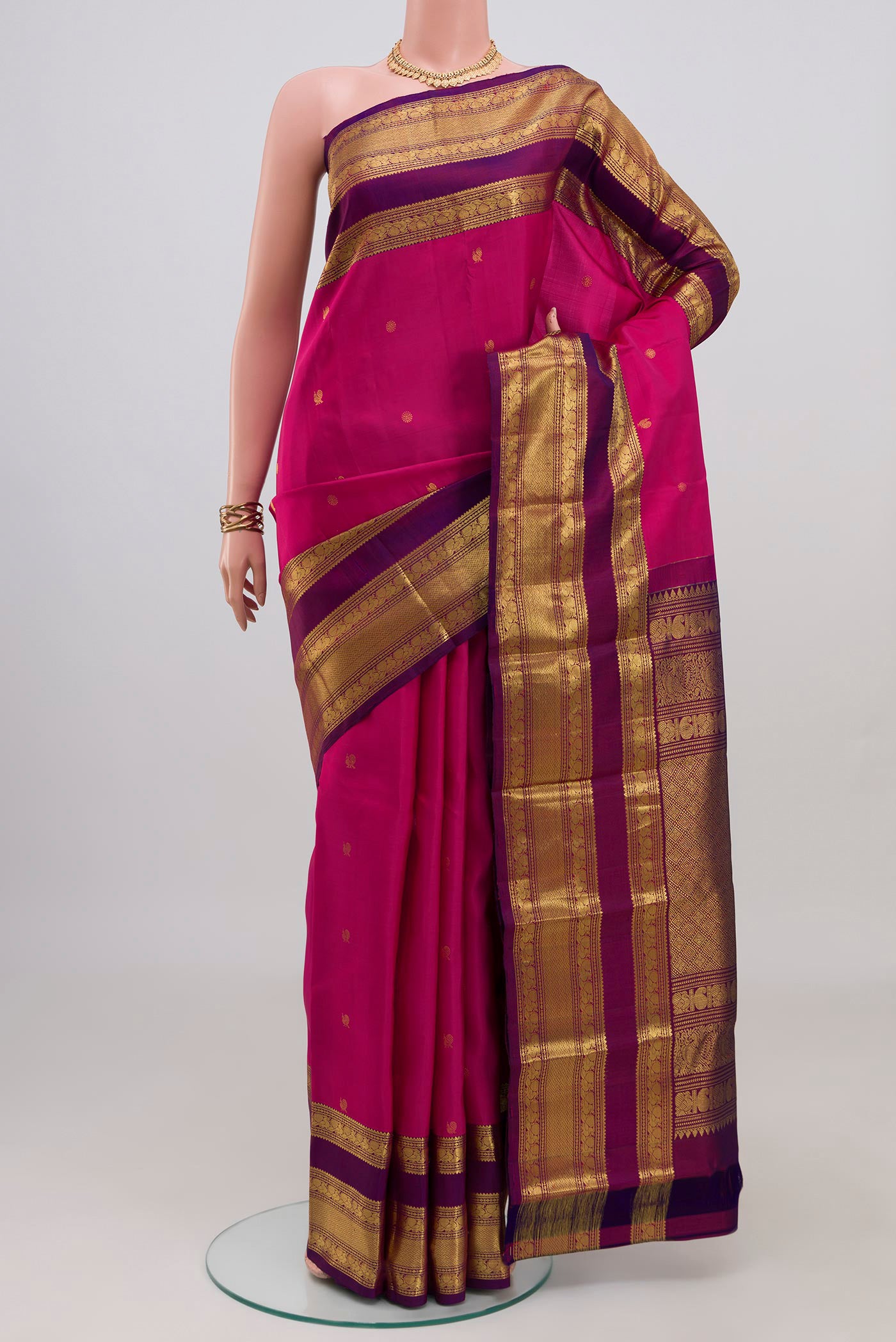 Pink Kanchipuram Silk Saree with Zari Butta on the body and Zari Border.  displayed on a mannequin