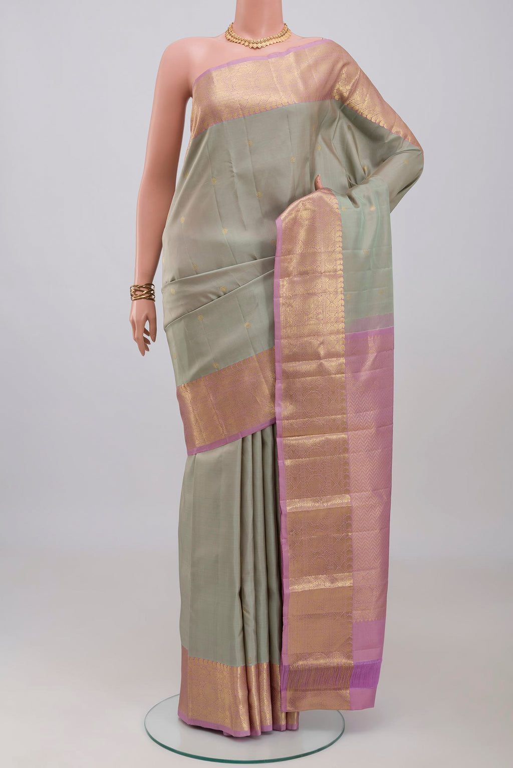 Grey Kanchipuram Silk Saree with Zari Butta on the body and Zari Border.  displayed on a mannequin