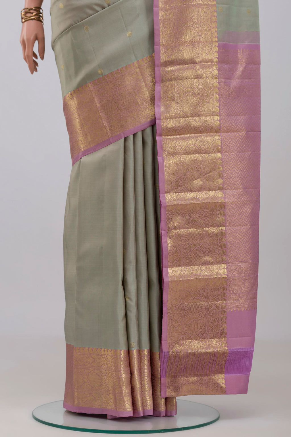 Pleats and pallu of Grey Kanchipuram Silk Saree with Zari Butta on the body and Zari Border. 