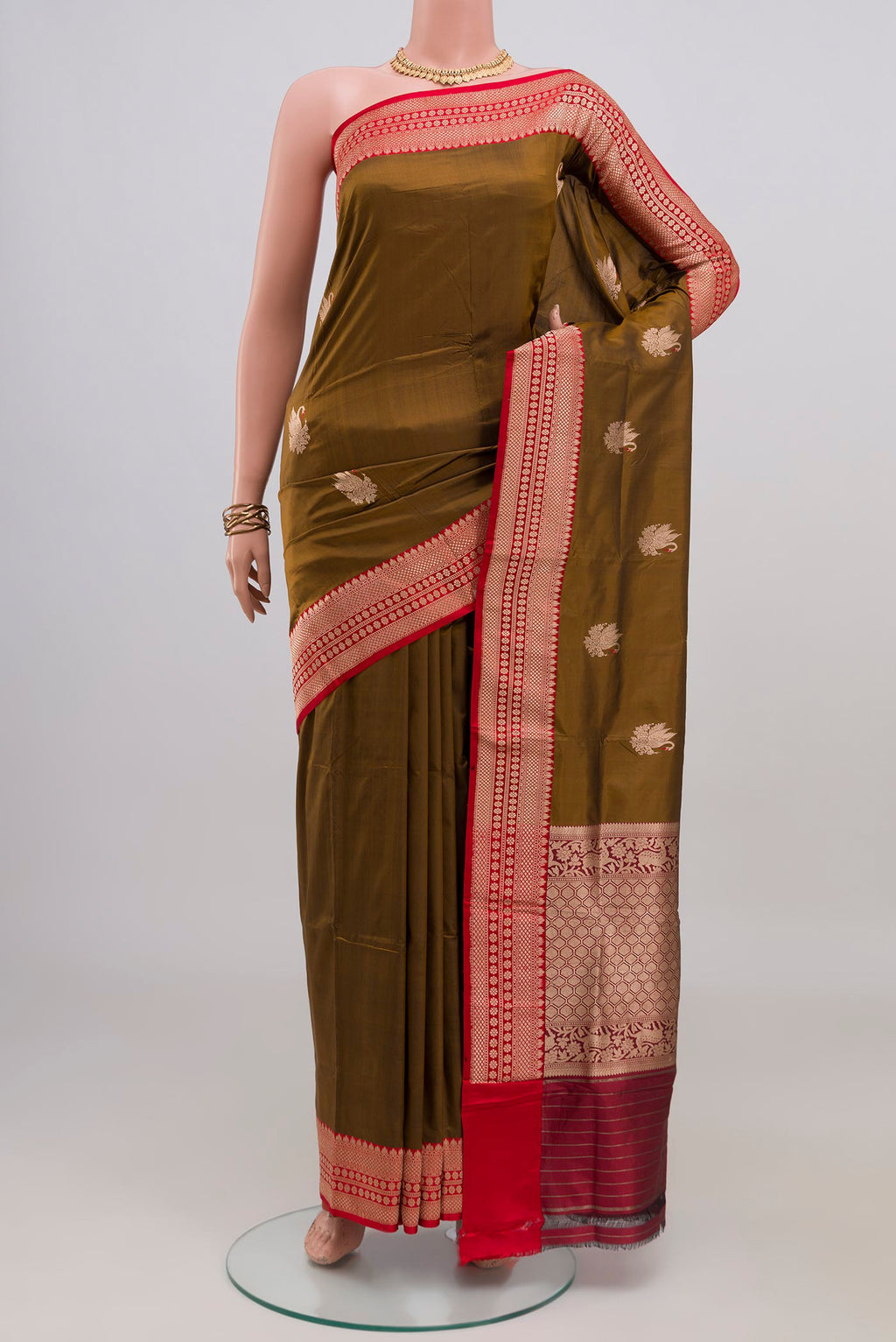Mehandi Green Banarasi Katan Silk Saree with Zari Butta on the body and Zari Border.  displayed on a mannequin
