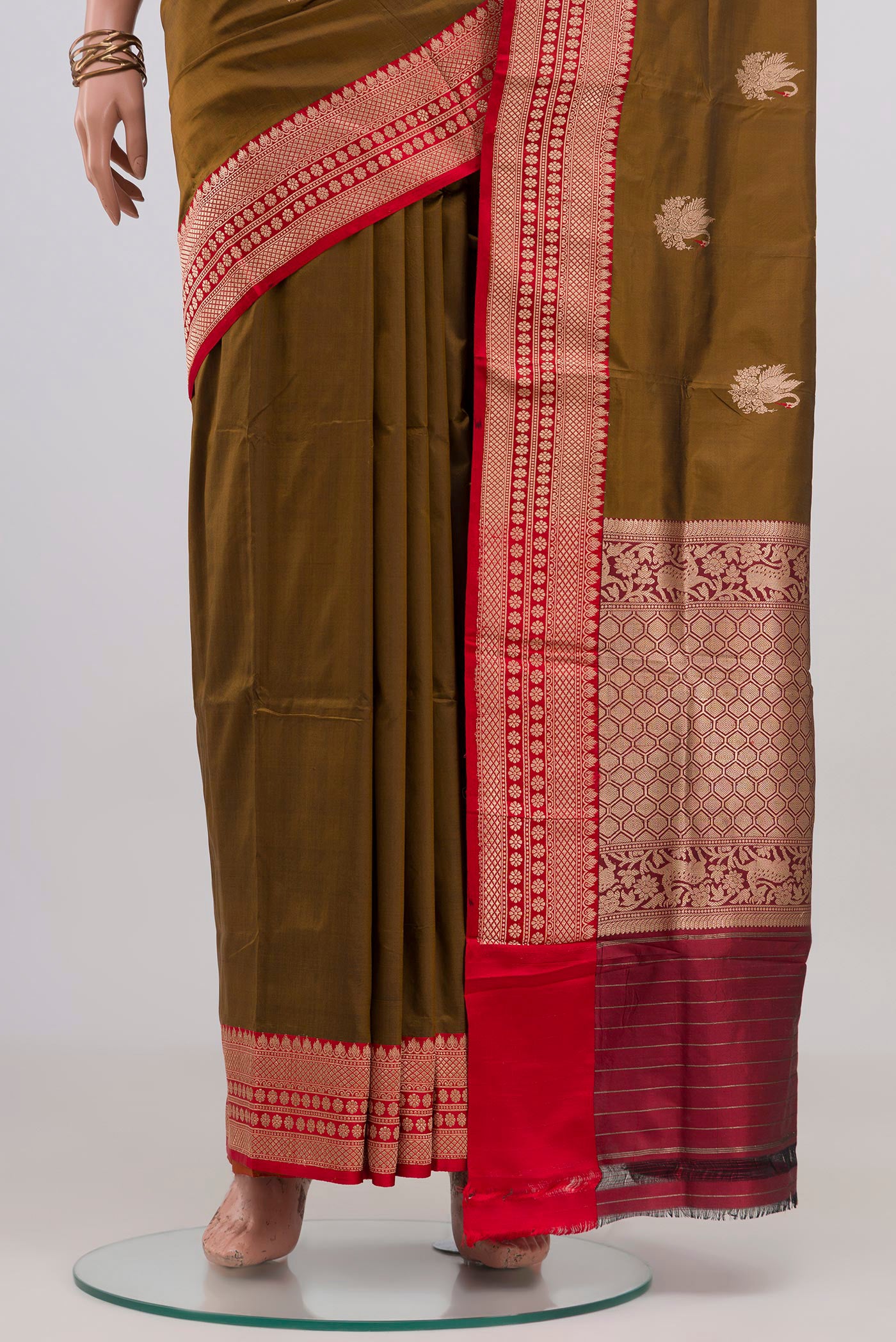 Pleats and pallu of Mehandi Green Banarasi Katan Silk Saree with Zari Butta on the body and Zari Border. 