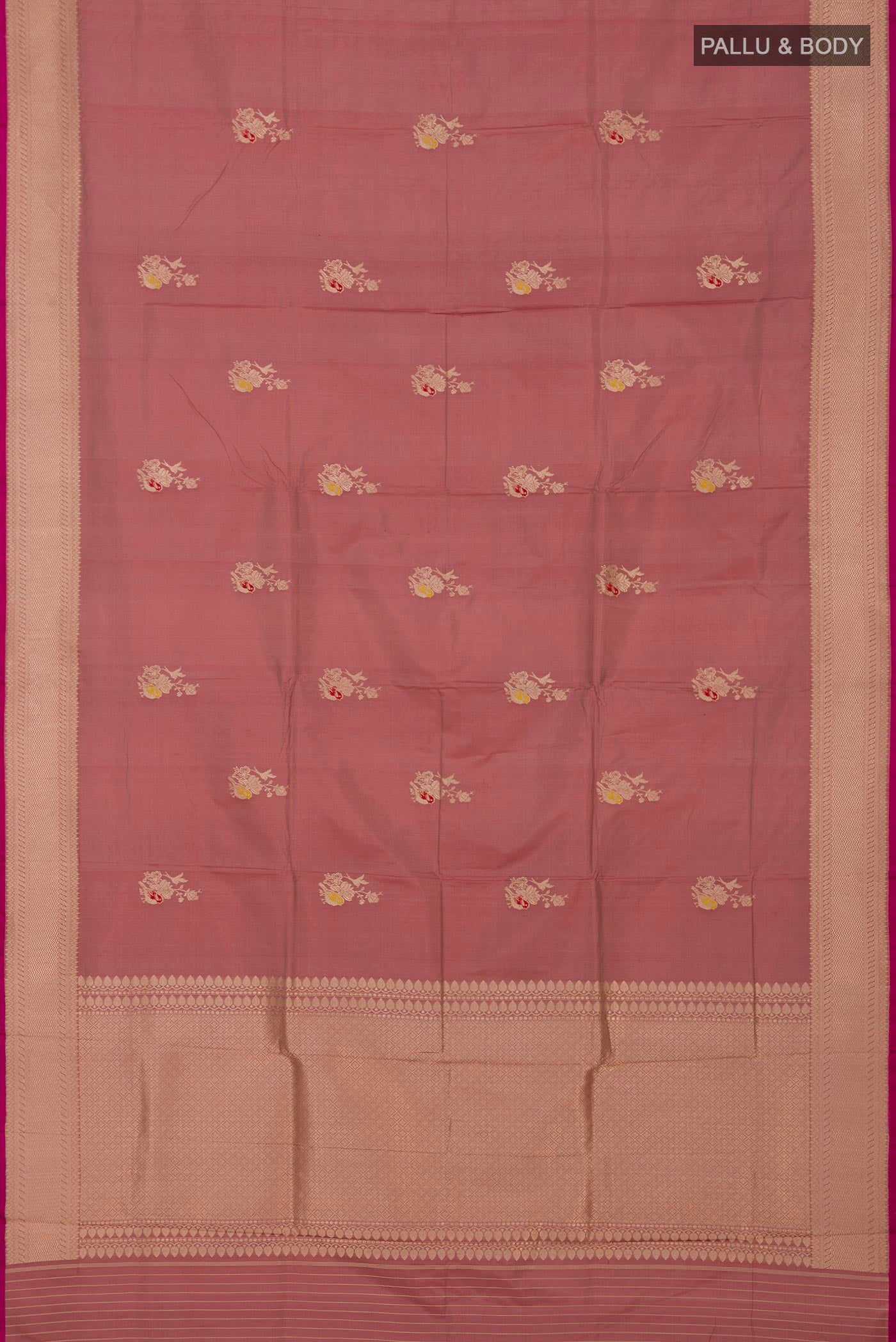Flat view of Rose Gold Banarasi Katan Silk Saree with Zari Butta on the body and Zari Border. 
