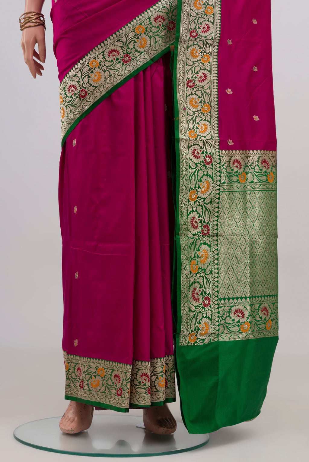 Pleats and pallu of Magenta Banarasi Katan Silk Saree with Zari Butta on the body and Fancy Border. 