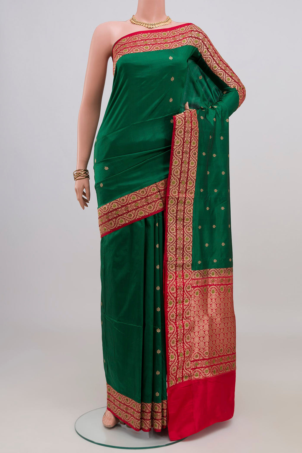 Green Banarasi Katan Silk Saree with Zari Butta on the body and Zari Border.  displayed on a mannequin