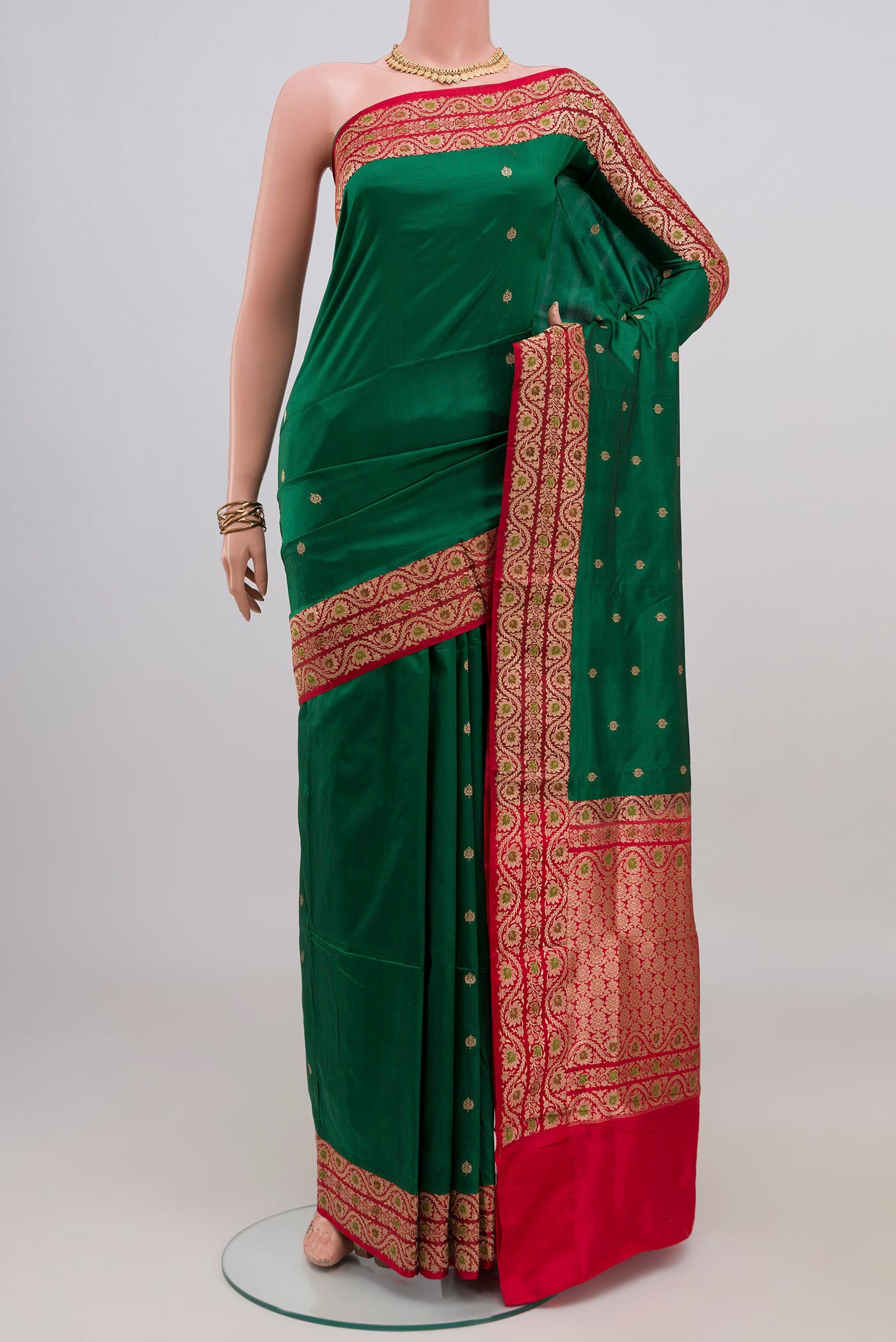 Green Banarasi Katan Silk Saree with Zari Butta on the body and Zari Border.  displayed on a mannequin