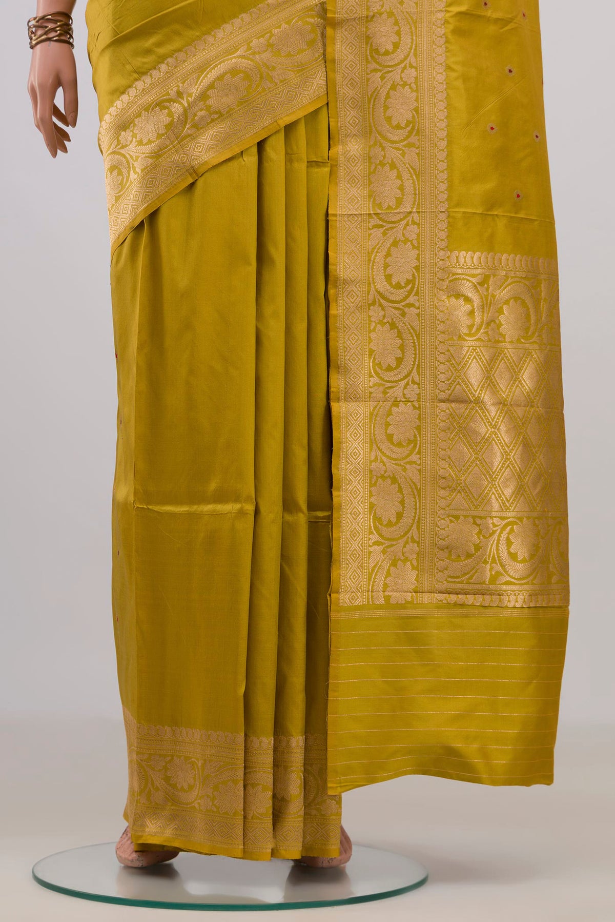 Pleats and pallu of Pure Silk Mustard Banarasi Katan Saree with Zari Butta on the body and Zari Border. 